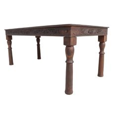 an old wooden table with two legs and a carved design on the top, against a white background