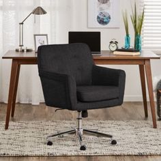 an office chair sitting in front of a desk with a laptop computer on top of it