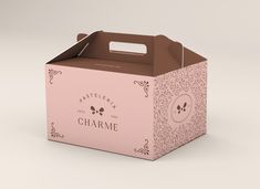 a pink box with a brown handle and skull design on the side that says charmme