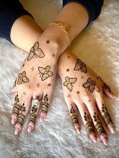 two hands with hendi tattoos on them