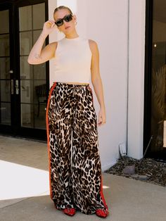 Satin leopard pants with red stripes down the sides. Relaxed fit. Features adjustable drawstring on elastic waist and pockets. Fits true to size. Sarah (5'7) is wearing a small.  100% Polyester. 4 Life, Spring Summer Fashion, Summer Style, Outerwear Jackets