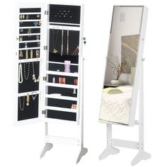 a white jewelry cabinet next to a mirror