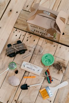 the contents of a craft kit laid out on a wooden table with scissors and other items