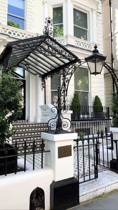 a black and white building with a bench in front