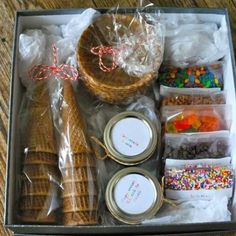 an open box filled with different types of food and confetti on top of a wooden table