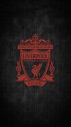 liverpool football club logo on a brick wall with red and black colors in the background