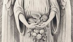 a statue of an angel holding a baby