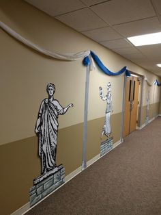 an office hallway decorated with wall art depicting the statue of liberty and two women holding hands