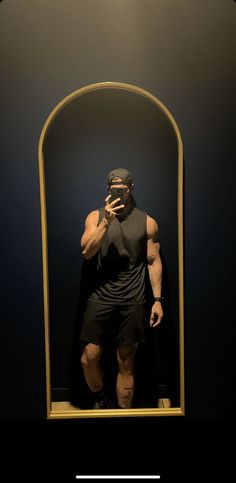 a man taking a selfie in front of a mirror with his cell phone up to his face