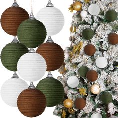 christmas ornaments hanging from the ceiling next to a tree with white and green balls on it