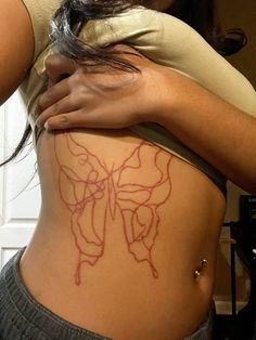 a woman with a butterfly tattoo on her stomach