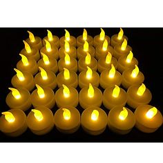 many lit candles are arranged in the shape of a triangle