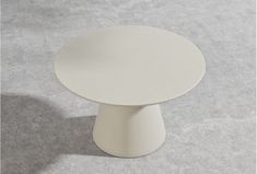 a white table sitting on top of a gray floor