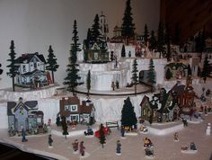 a christmas village is displayed on a table