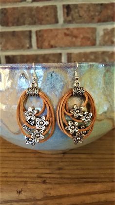 the earrings are made with wood and metal