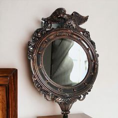 an ornate mirror sitting on top of a dresser