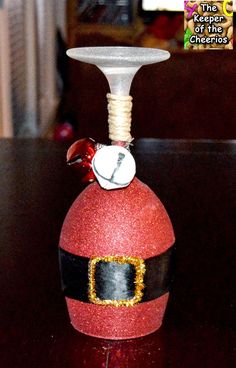 a red wine bottle with a santa clause hat on it