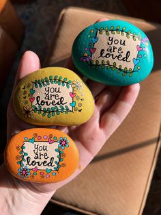 two painted rocks that say you are loved, you're loved and you are loved