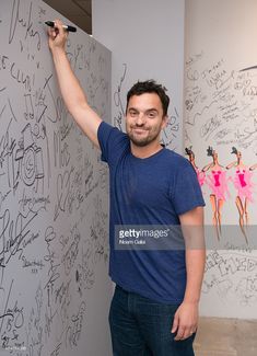 a man writing on a whiteboard in an office