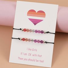 Introducing our Beaded Lesbian Couple Bracelet Set 2PC - a beautiful and meaningful way to show your love and support for the LGBTQ+ community with this lesbian pride jewelry. The set includes two bracelets, each featuring a strand of colorful beads in the Sunset Lesbian Pride Flag, specifically designed as a lesbian flag bracelet. The beads are interspersed with delicate silver-colored spacers, adding a touch of elegance to the design of this lesbian bead bracelet. These Beaded Lesbian Couple B Lesbian Flag Bracelet, Pride Jewelry, Lesbian Pride Flag, Acrylic Bracelet, Pride Flag Colors, Pride Jewellery, Pride Bracelet, Lesbian Flag, Couple Bracelet