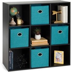 a black shelf with blue bins and books