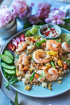 a plate with rice, shrimp and vegetables on it