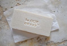 a soap bar with the words be our guest on it