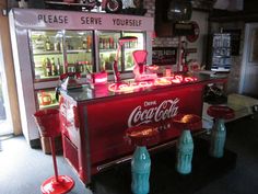 an old fashioned coca - cola machine is on display in a store with other items