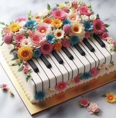 a cake decorated with flowers and piano keys