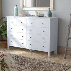 a white dresser and mirror in a room