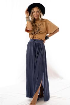 The Stasia Maxi Skirt is a moment! It features a high waisted silhouette, smocked drawstring waistband, a one side slit from the waist down to the hem and a silky, shiny slightly fabric. A perfect piece to dress up or down. We love it with a bold graphic tee for a day out on the town! *Due to lighting and differences in monitors, actual colors may vary slightly from what appears online. Model is 5'4" and wearing a size Small. Approximate measurements are as follows: SMALL: Waist: 28", Length: 40 Boho Skirt Outfit, Blue Maxi Skirt Outfit, Blue Skirt Outfits, Crochet High Neck, Maxi Skirt Outfits, Tiered Maxi Skirt, Shiny Fabric, Blue Skirt, Boho Outfits