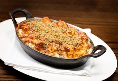 a casserole dish on a white plate topped with cheese and parmesan