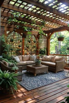 an outdoor living area with couches, tables and potted plants on the deck