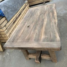 a wooden table sitting on top of a pile of pallets