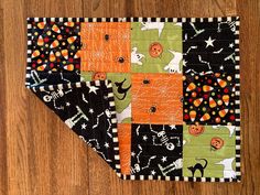 a patchwork halloween quilt on a wooden floor