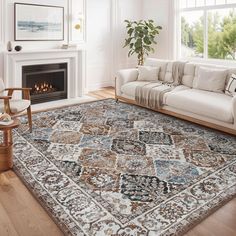 a living room filled with furniture and a large rug on top of a hard wood floor