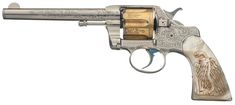 a silver and gold revolver with an eagle engraved on it's side, isolated against a white background