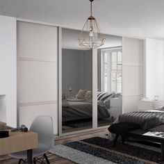 a bedroom with mirrored closet doors and a bed