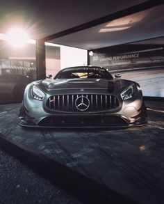 a mercedes sports car parked in a garage