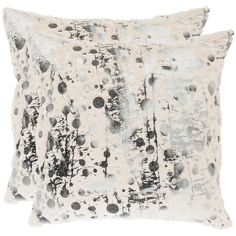 a black and white pillow with circles on it's side, in front of a white background