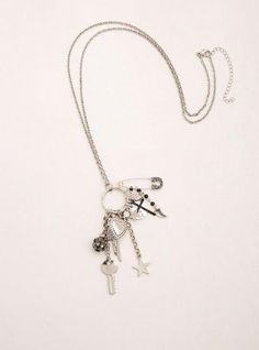 Everything a goth gal loves, all on one necklace! This mid silver tone chain rocks steady with rock 'n' roll charms - from a bedazzled safety pin, to skulls, to a lightning bolt. Lobster clasp. 31. 5” long with 3” extender. Base metals. Imported. The best plus size women's skull safety pin charm necklace necklaces in silver. Torrid is your destination for cozy fall and winter clothes to keep you warm and comfortable.