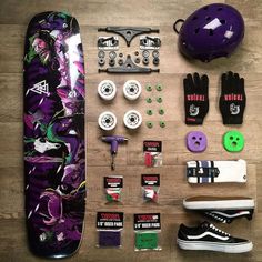 the contents of a skateboard laid out on top of a wooden floor next to it