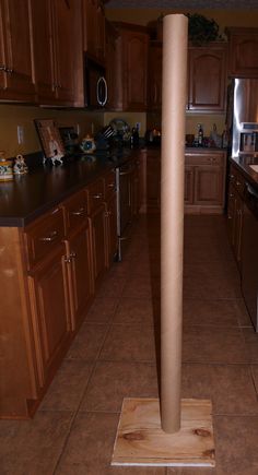 a kitchen with wooden cabinets and black counter tops is seen in this image from the doorway