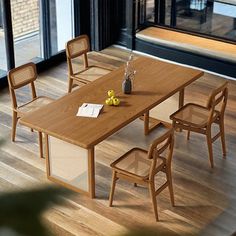 a wooden table with four chairs around it