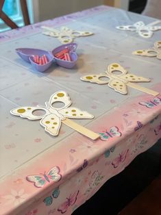 the table is covered with paper cut outs and butterfly shaped decorations on top of it