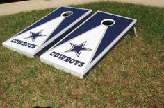 two cornhole game boards with the word cowboys on them