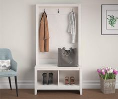 a white coat rack with shoes and purses on it next to a blue chair