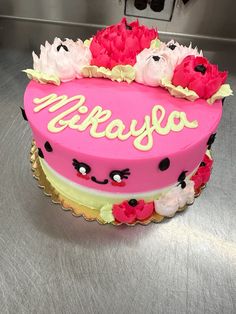 a pink cake with white and red flowers on it that says mammafoo