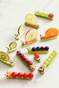 various fruits and vegetables are arranged in the shape of caterpillars with eyes on them