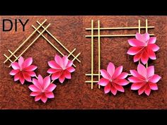 paper flowers and bamboo sticks are arranged on a wooden surface with the words diy written in